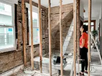 lady looking at wall being renovated